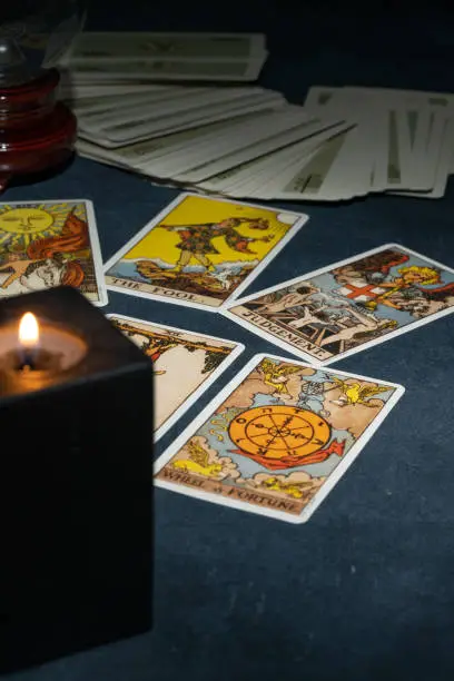 Tarot cards arranged beside a candle